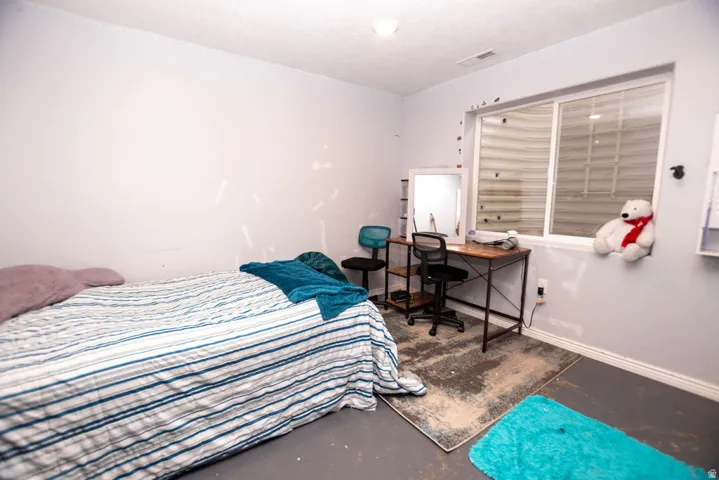 Spacious room featuring light gray walls, a built-in window sill, a white-framed window, and a ceiling light fixture