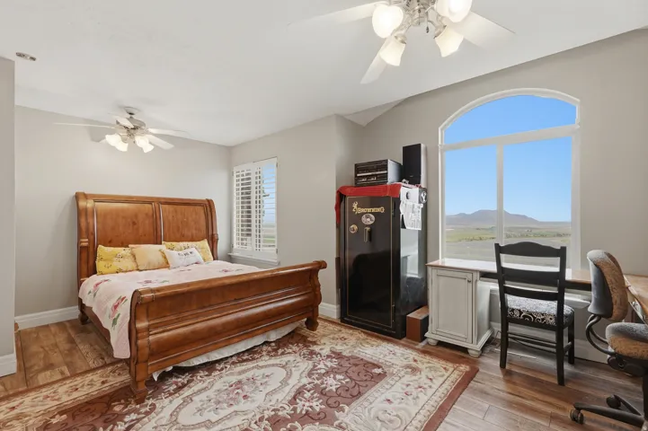 Arched window framing distant mountains and expansive sky