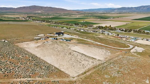 Expansive undeveloped land parcel featuring a partially cleared building area and surrounding natural vegetation