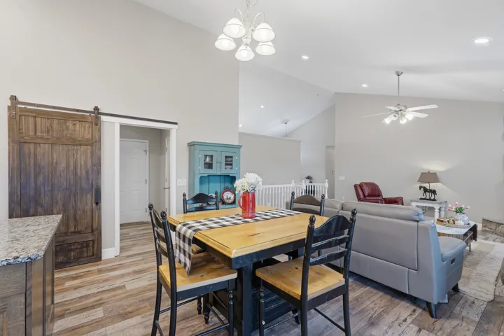 Open-concept living area with vaulted ceilings and recessed lighting