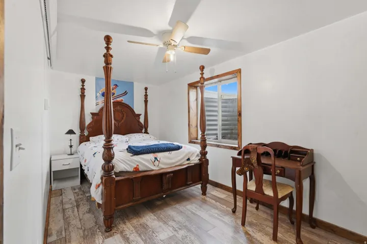 Room featuring light wood-finish flooring, white walls, and a white ceiling with a ceiling fan