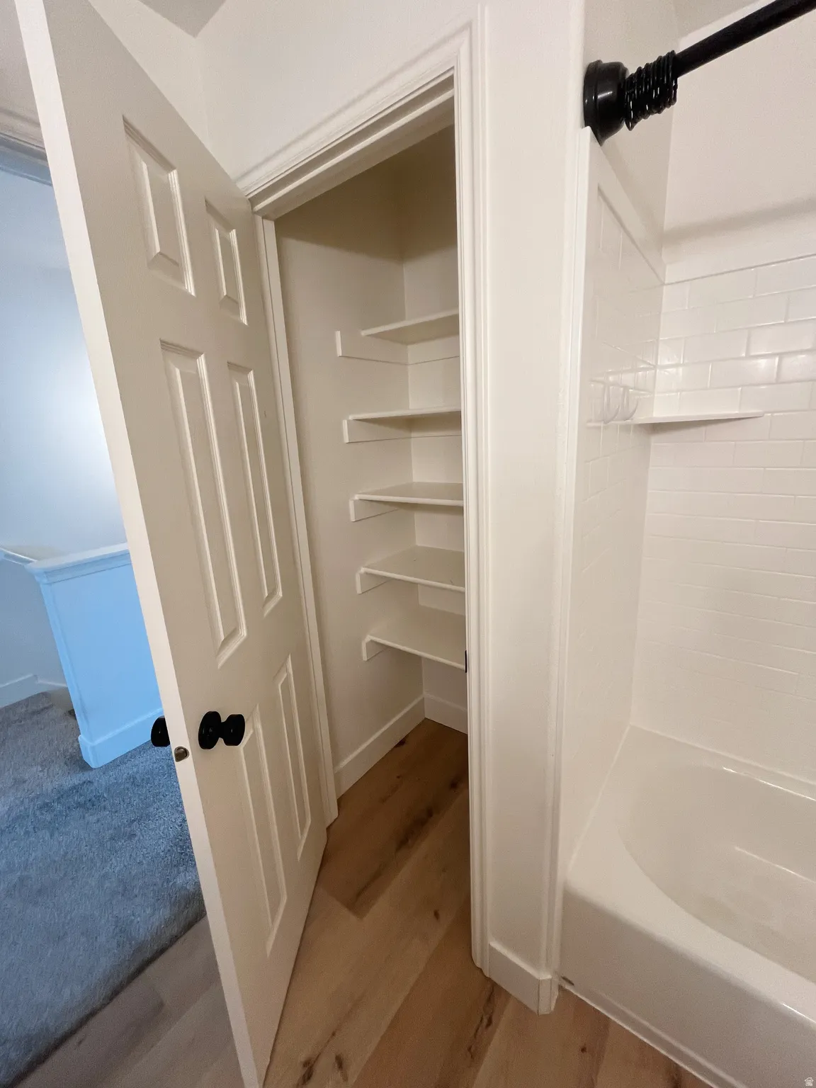 Bathroom with white subway tile shower surround and built-in shelving