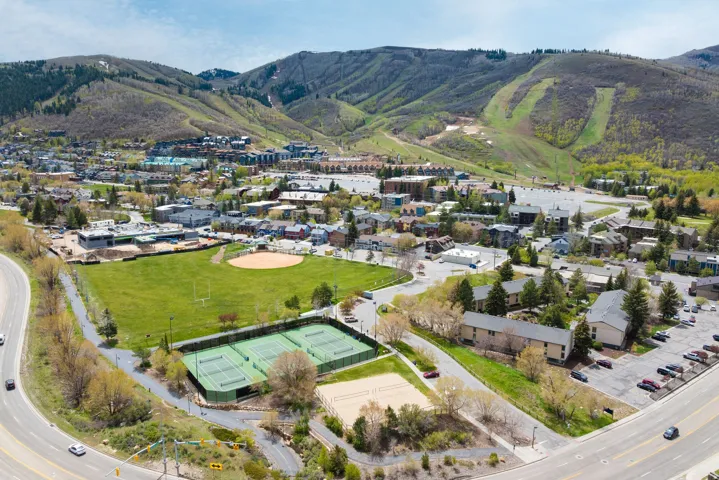 Expansive green space featuring a baseball diamond and football field