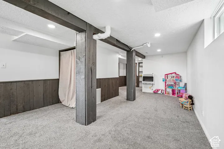 Spacious room with gray carpeting and white walls