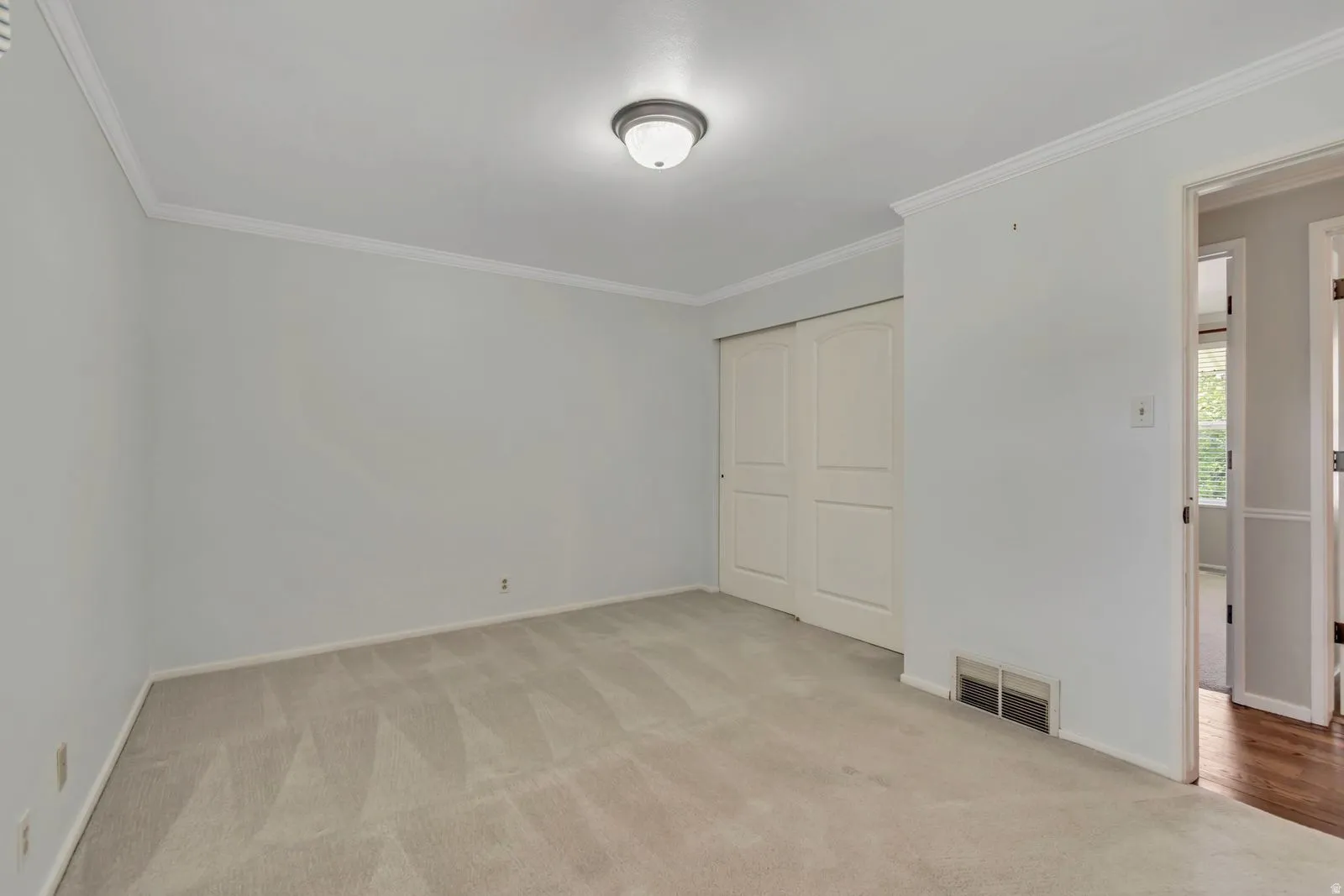 Neutral tone wall paint with white crown molding