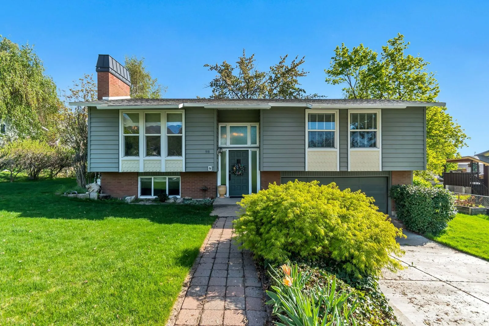Split-level residence featuring a brick and siding exterior