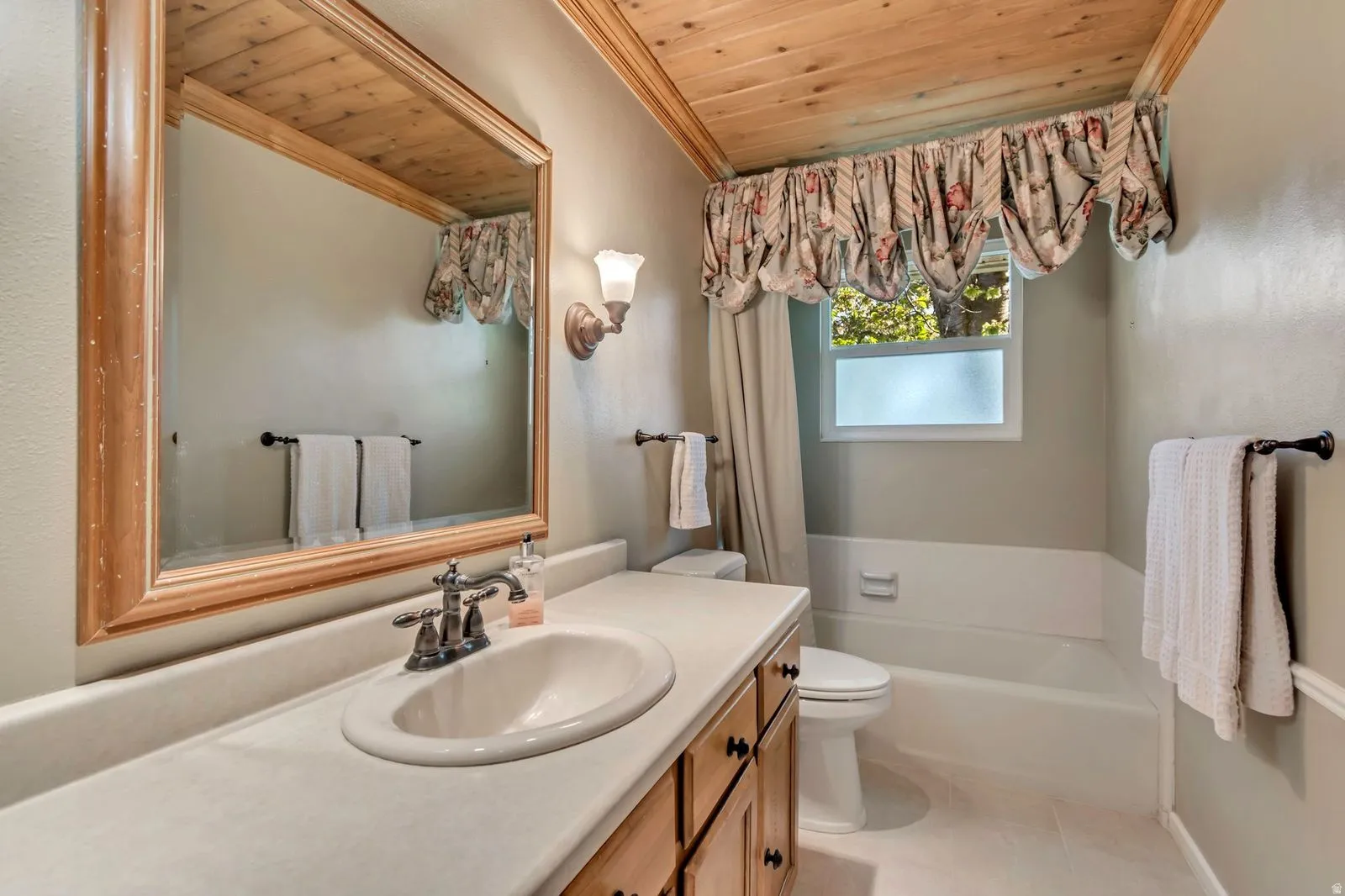 Bathroom featuring a light wood plank ceiling