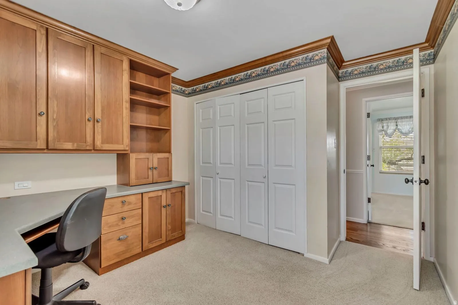 Built-in wood cabinetry and shelving with integrated desk space