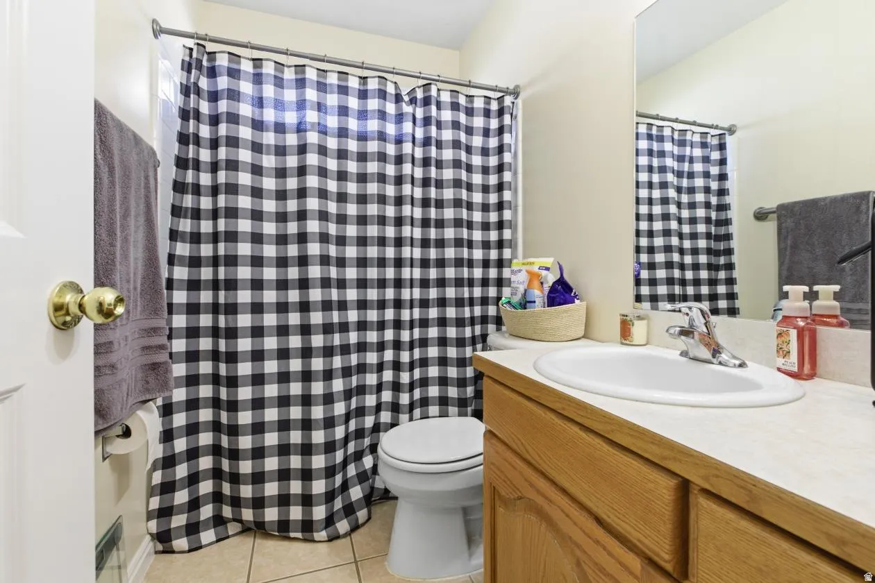 Bathroom featuring a light-toned vanity with an integrated sink and chrome faucet, a mounted mirror, and neutral-toned wall paint