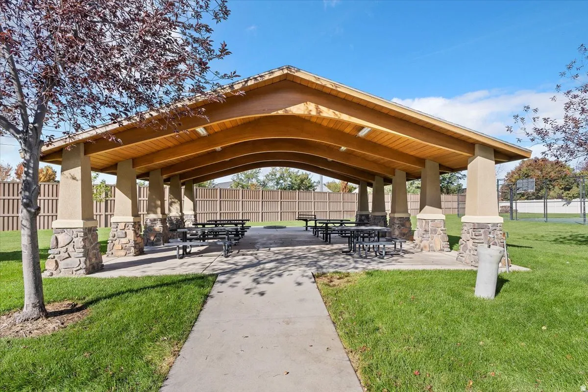 Covered pavilion featuring a wood-finish ceiling and stone-accented columns