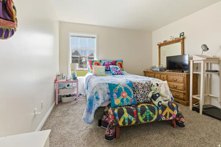 Neutral-toned walls and textured carpeting create a versatile interior