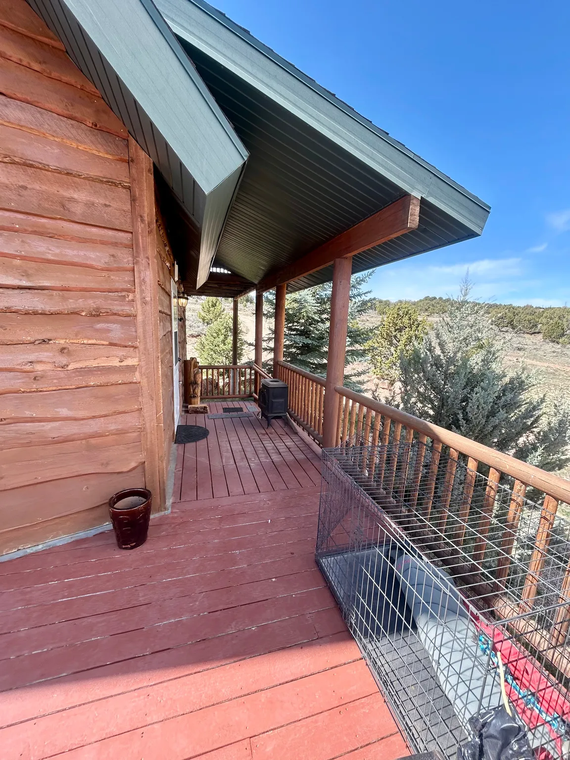 Expansive outdoor deck featuring wood-finish flooring and a wood railing