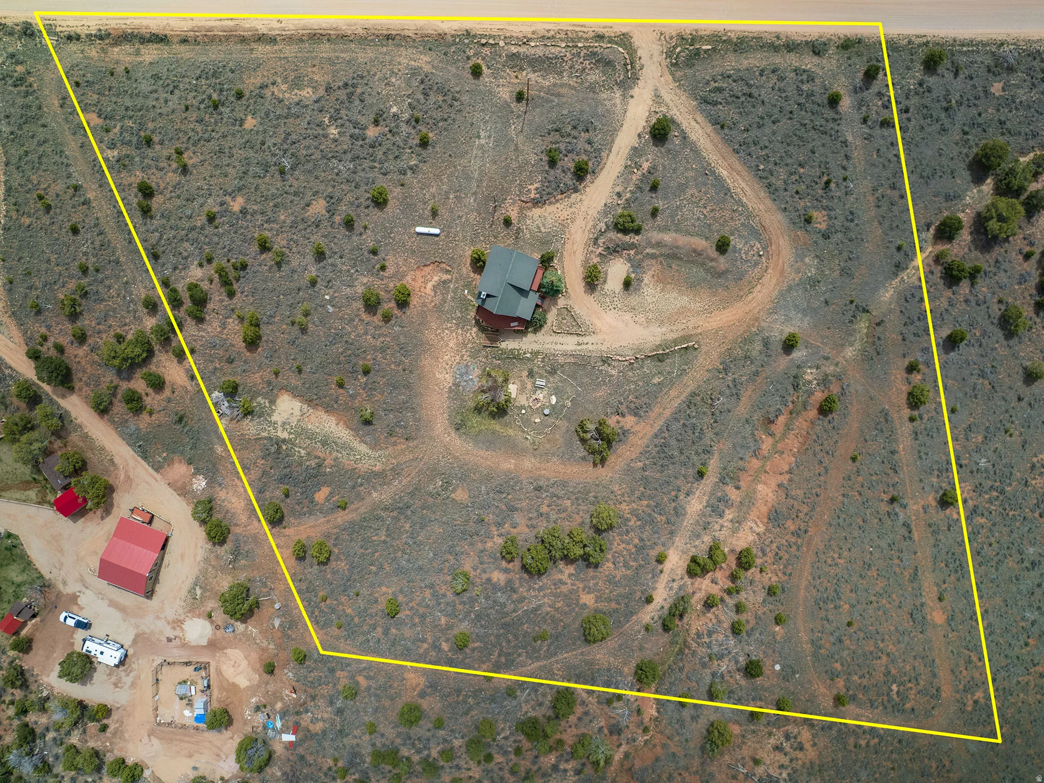 Aerial view of sparsely populated area featuring a desert landscape and property boundaries highlighted