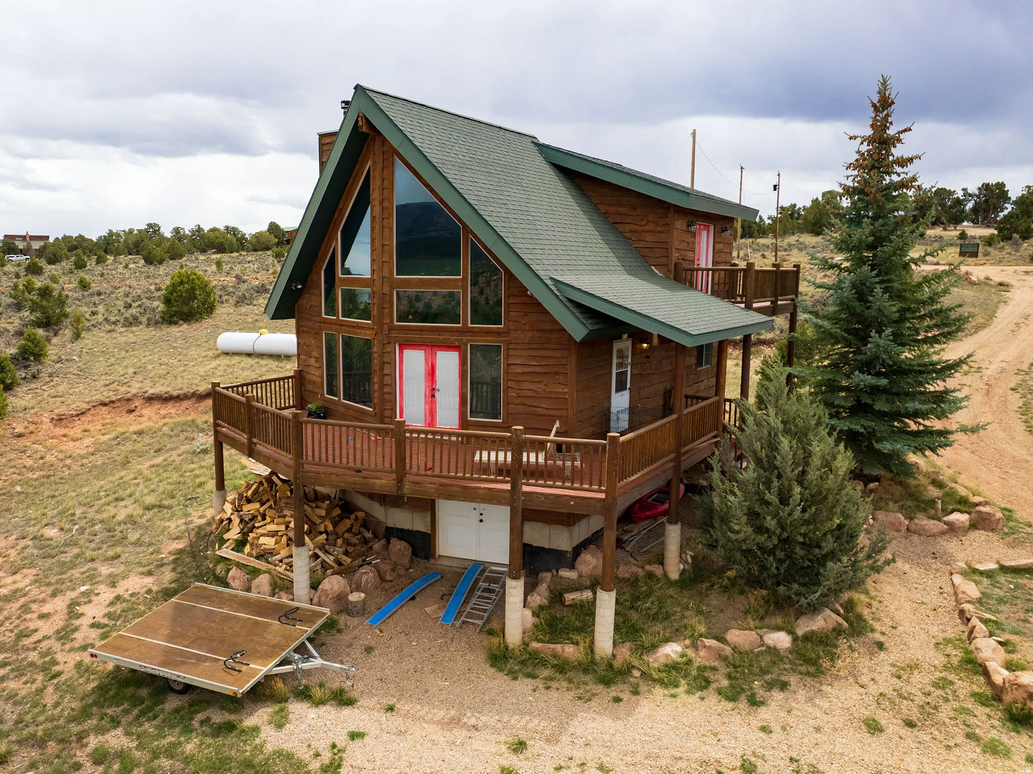 Back of property with a deck, roof with shingles, and a chimney
