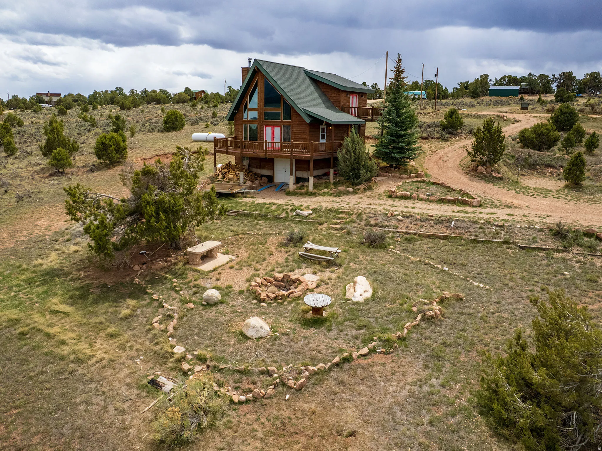 Rear view of house with a wooden deck, a view of rural / pastoral area, and a chimney