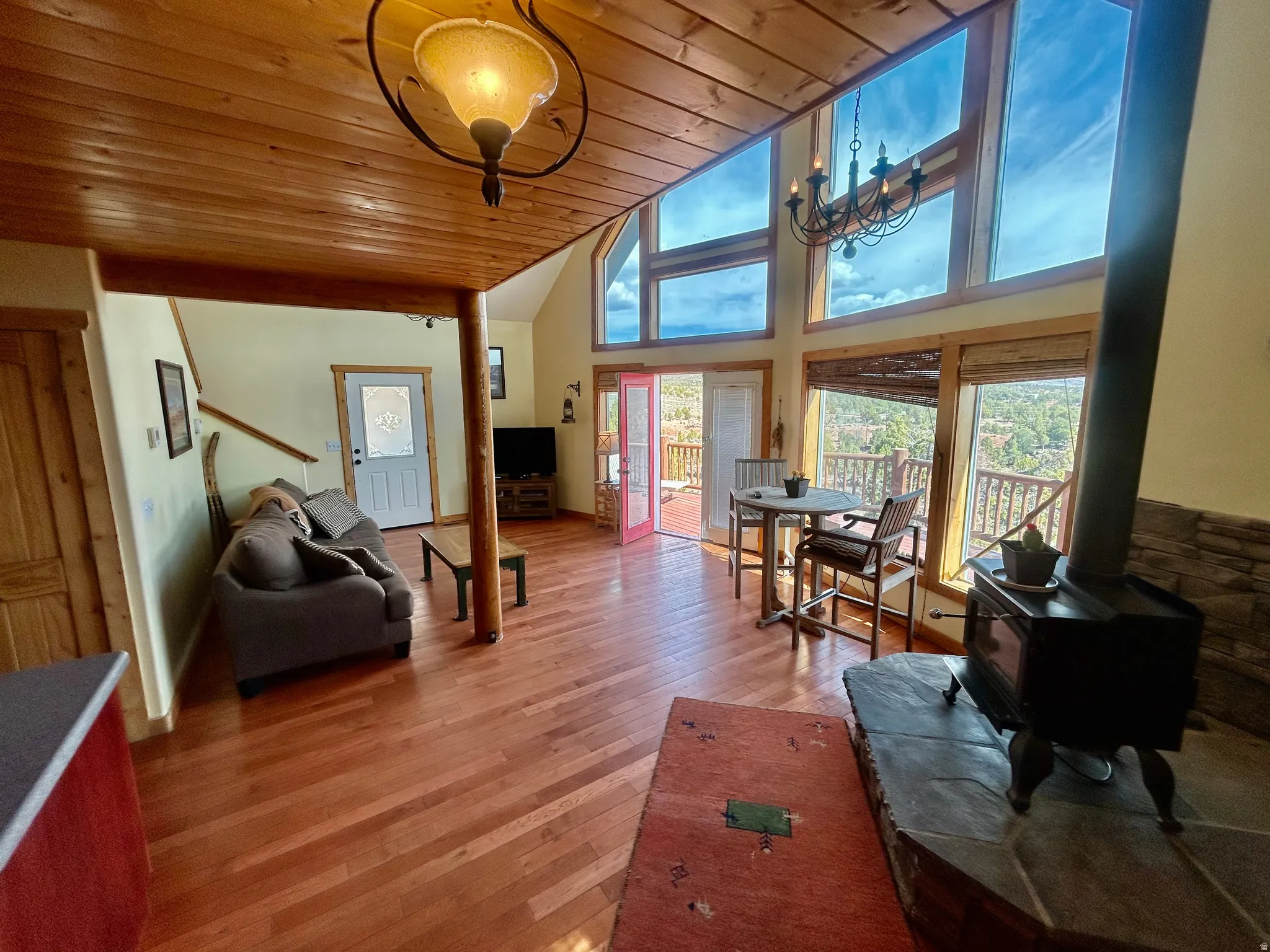 Living area with wood-finish flooring and a wood-paneled ceiling