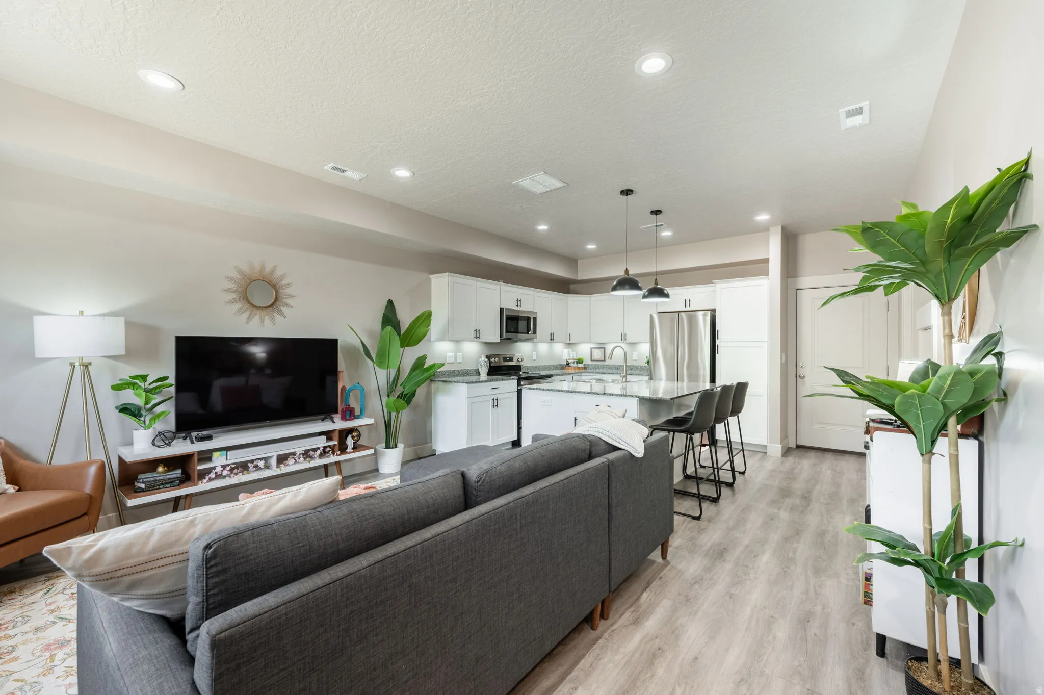 Open-concept living space featuring wood-finish flooring throughout