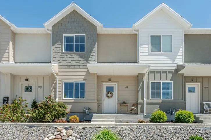 Multi-unit dwelling featuring a varied facade with horizontal siding, shake siding, and stucco finishes