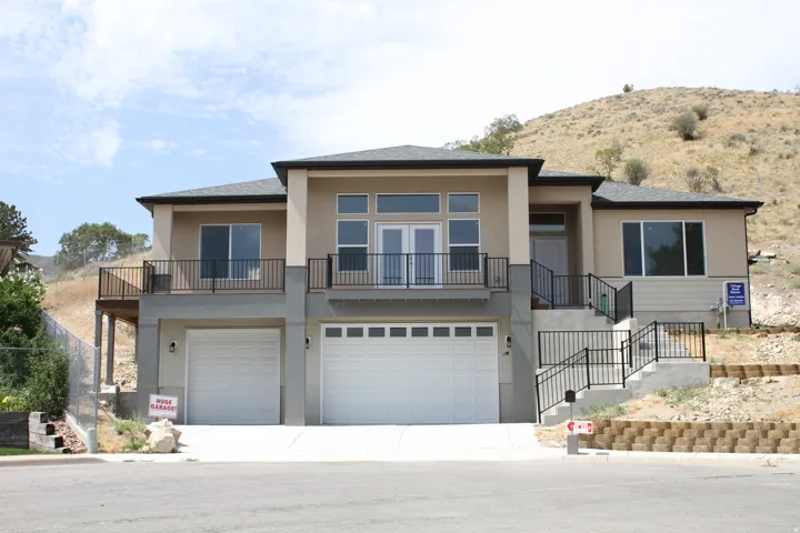 Contemporary split-level residence featuring a multi-tone stucco exterior