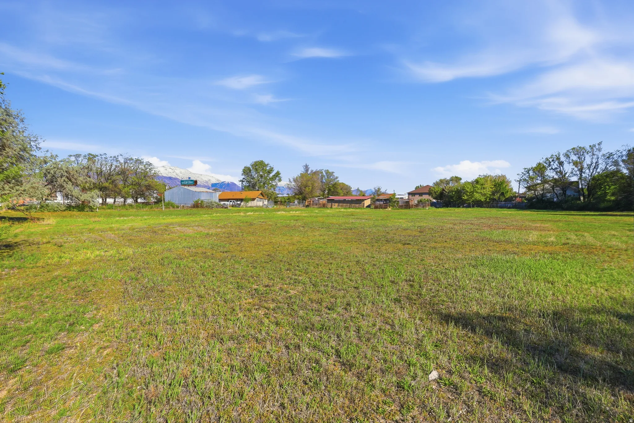 Expansive open lot featuring a distant mountain range backdrop