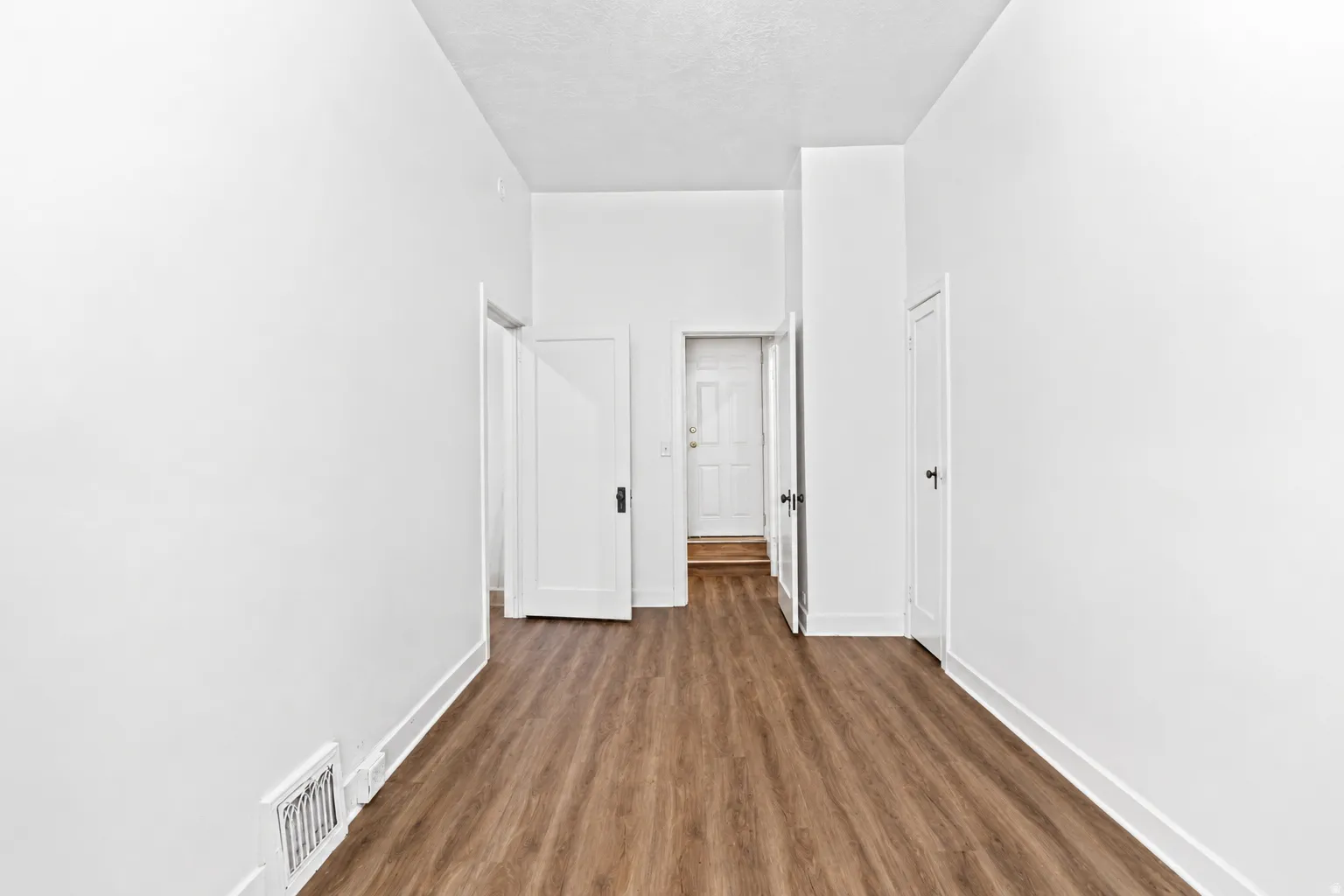 Entryway featuring wood-finish flooring and white baseboards