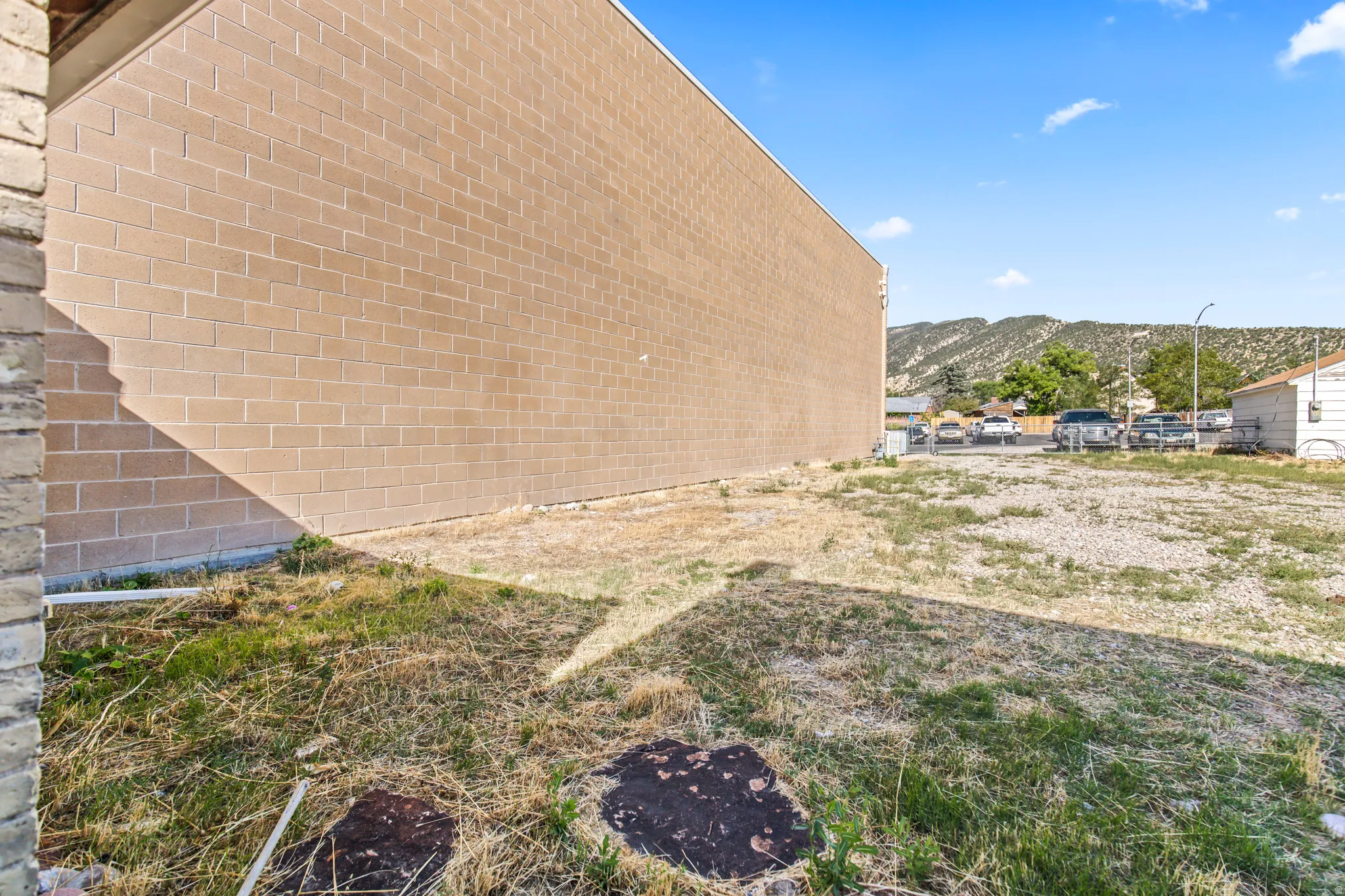 Expansive lot featuring a tan brick block building