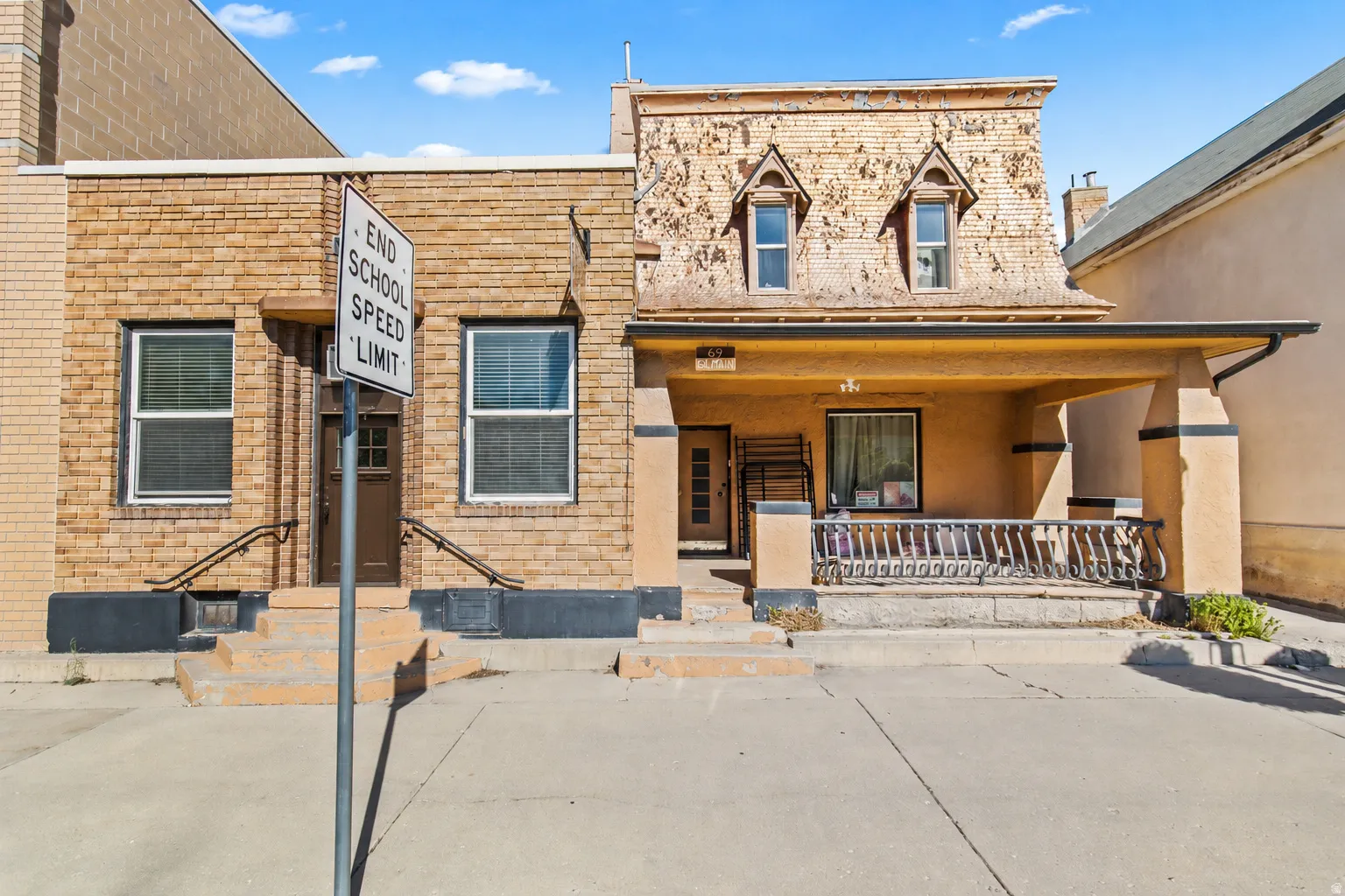 Brick and stucco exterior featuring multiple entryways