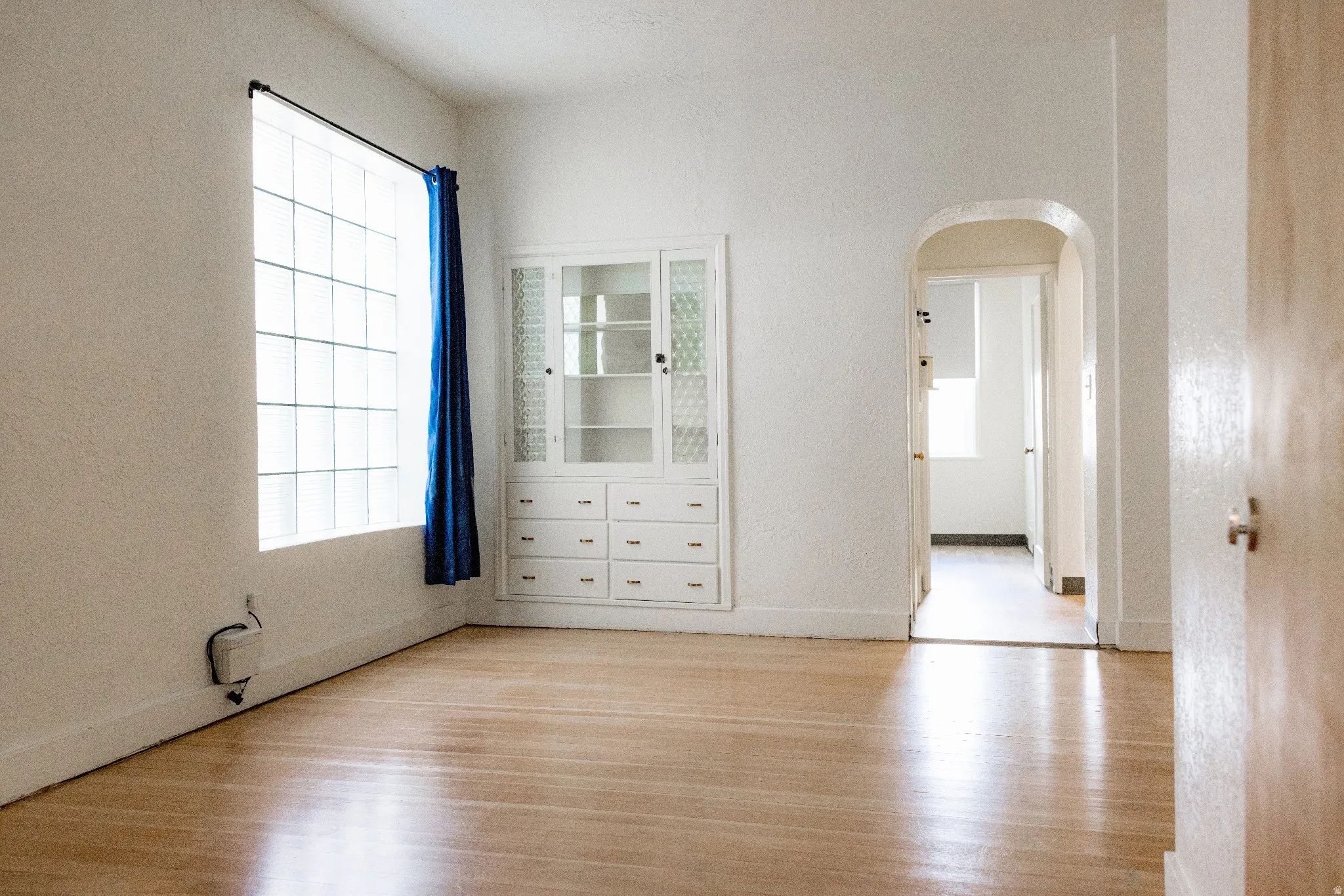 Hardwood flooring and textured walls define this interior space