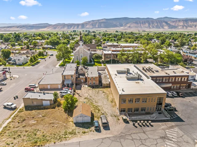 Expansive commercial lot featuring direct street frontage, clear topography, and established adjacent structures
