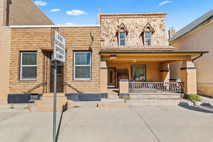 Brick and stucco exterior featuring multiple entryways
