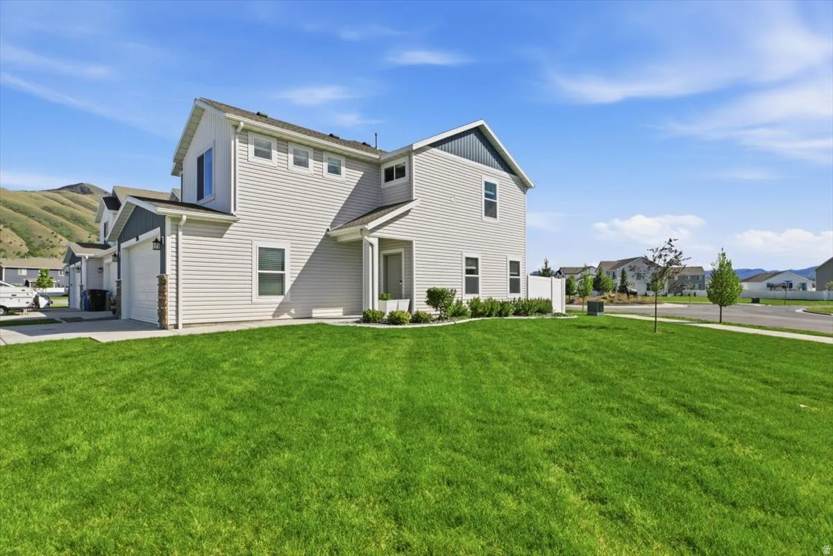 Contemporary two-story residence featuring light-toned siding and dark accent gables