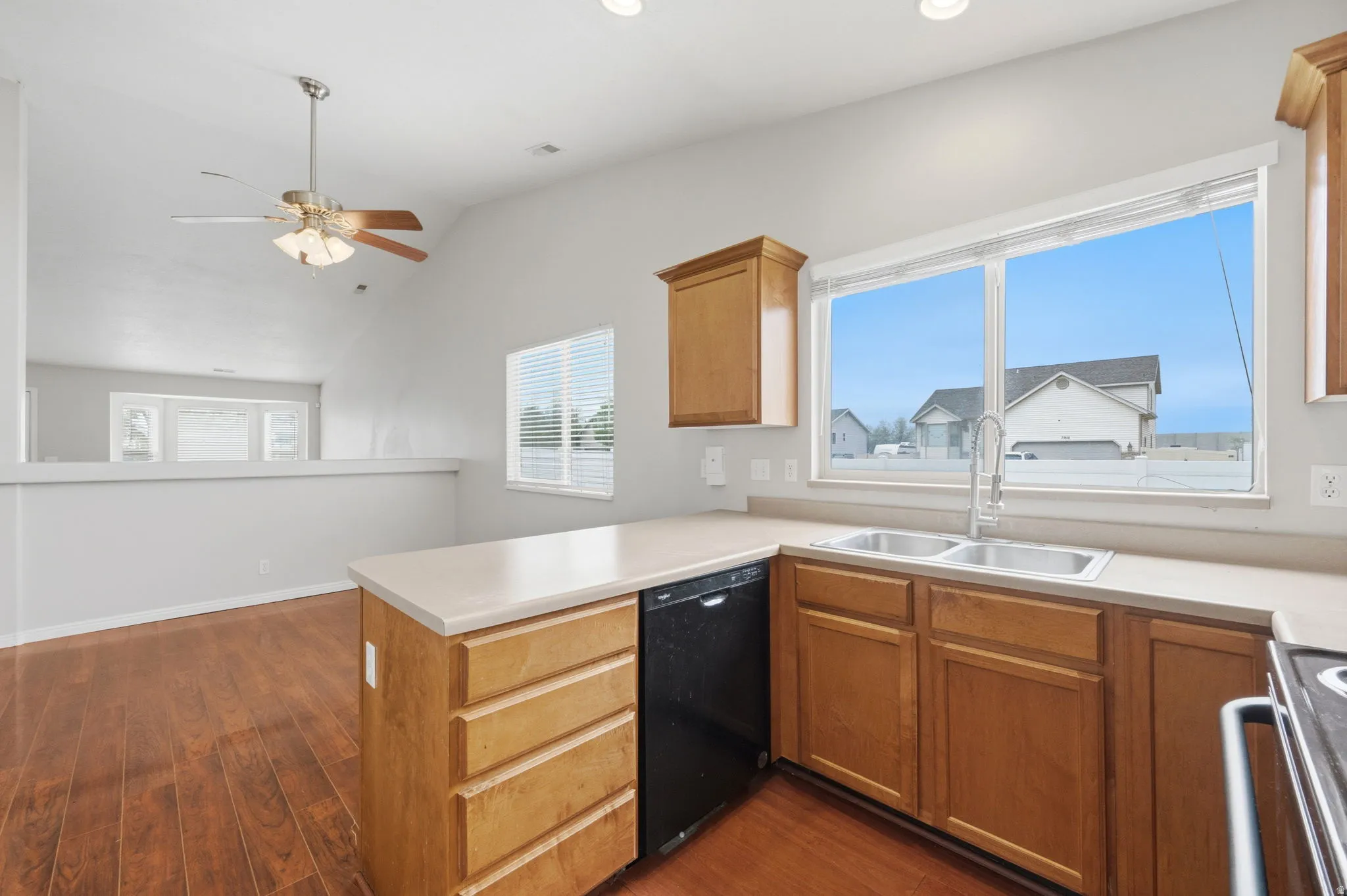 Kitchen featuring wood-finish flooring, light-toned countertops, and wood cabinetry