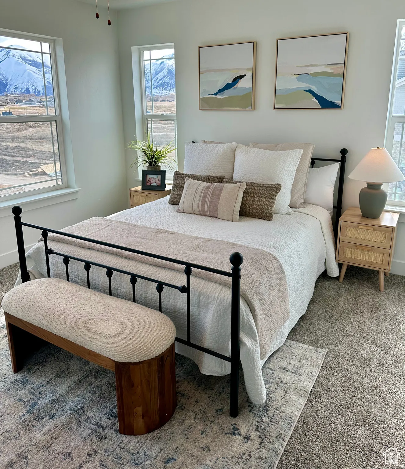 Bright bedroom featuring plush carpet flooring and multiple windows