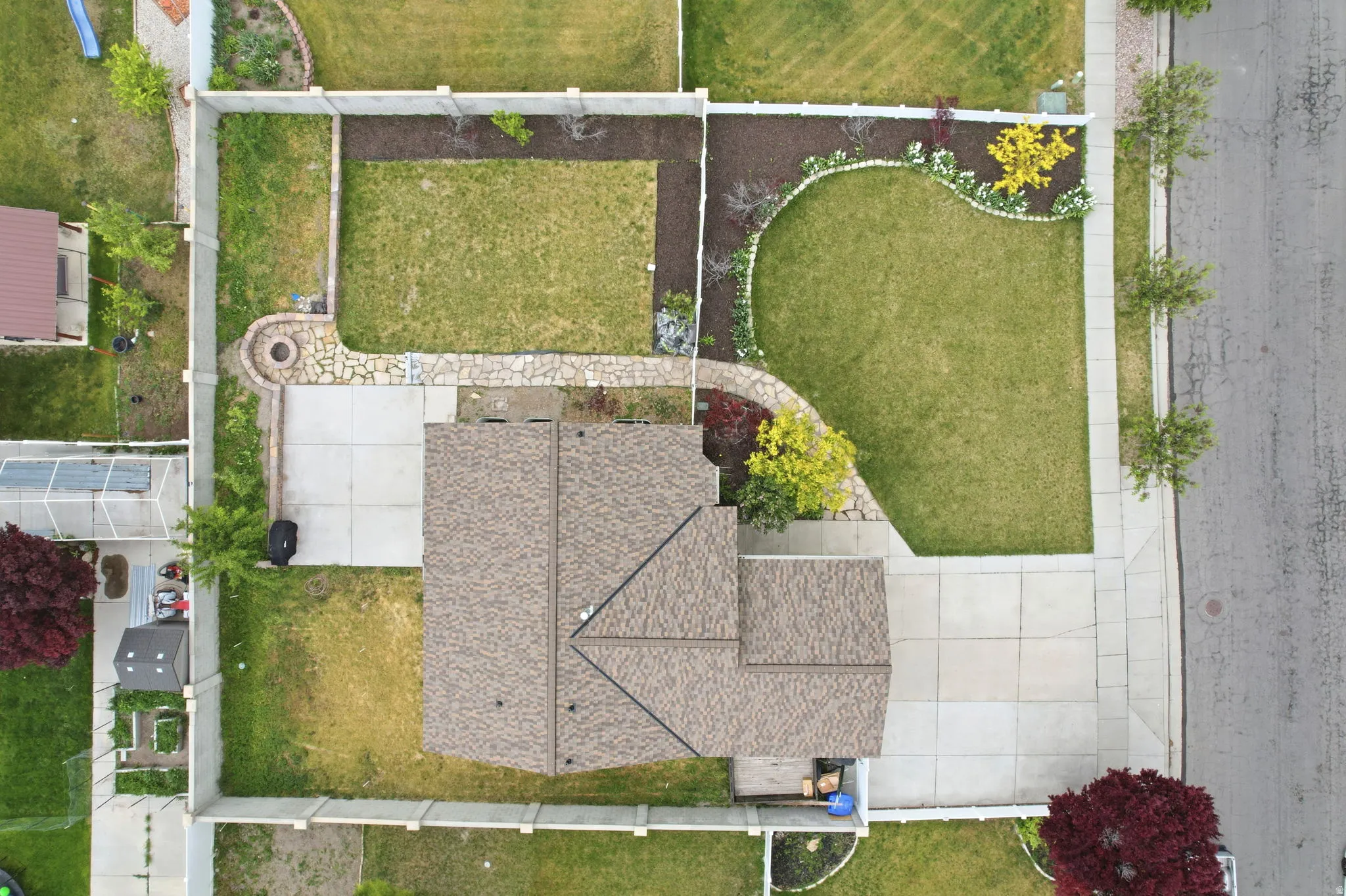 Expansive property with a shingled roof and concrete driveway
