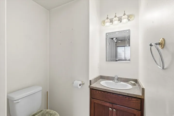 Vanity featuring a dark wood-finish cabinet with double doors, an undermount sink, and a countertop