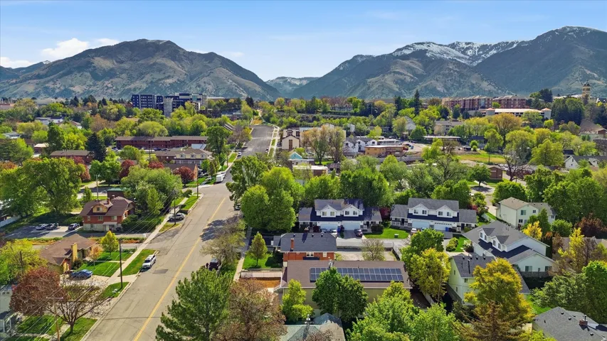 Residential neighborhood featuring a diverse collection of homes, mature trees, and paved streets