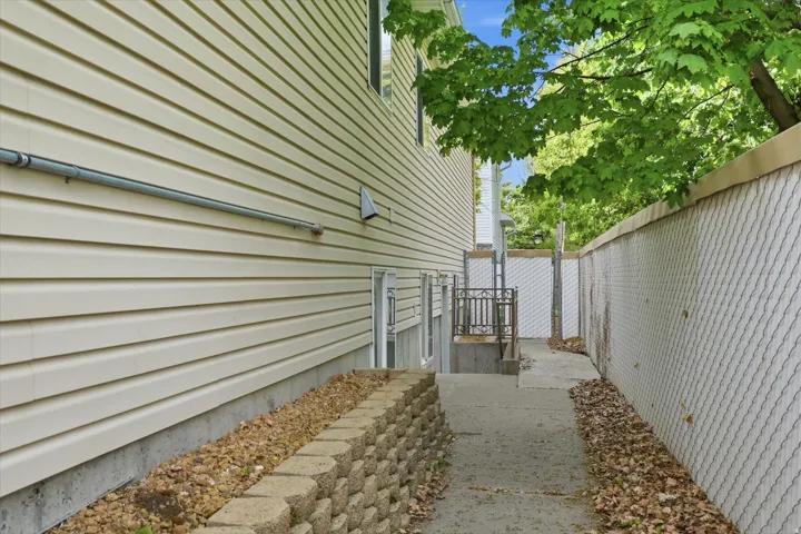 Beige horizontal siding exterior with a concrete foundation