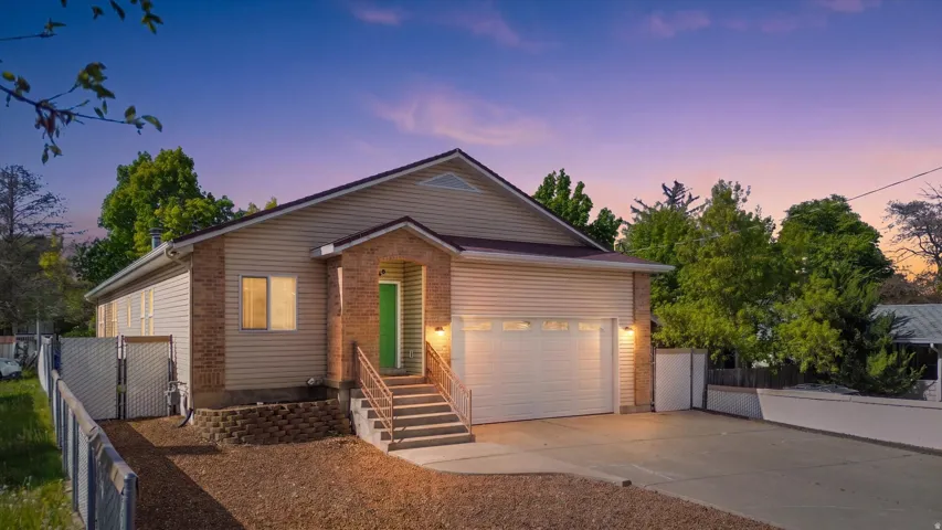 Contemporary residence featuring a brick and siding exterior