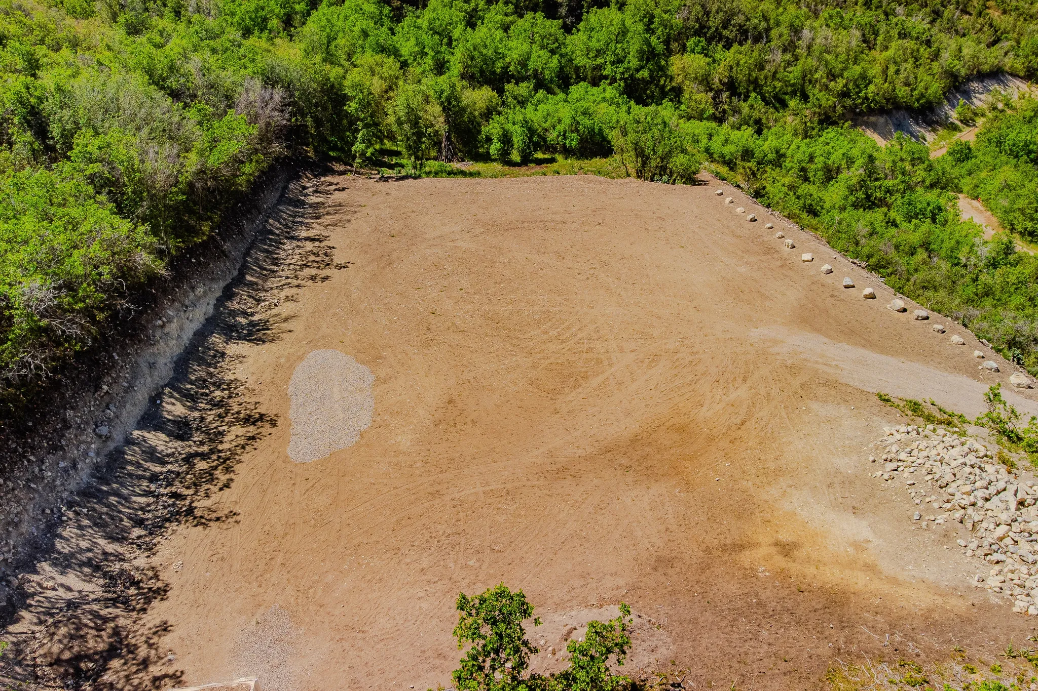 Expansive graded lot with natural tree line perimeter