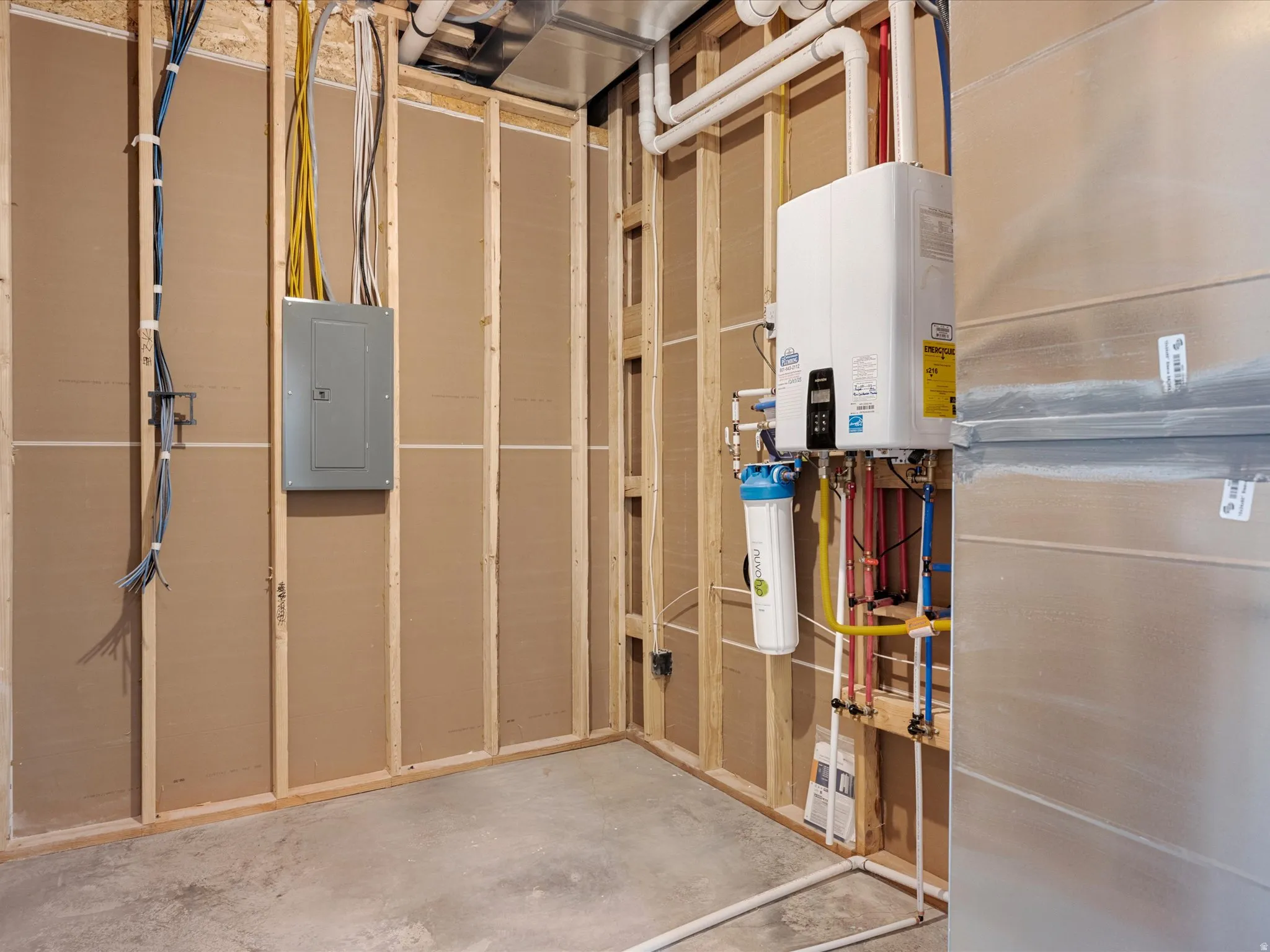 Utility area with concrete flooring and framed walls