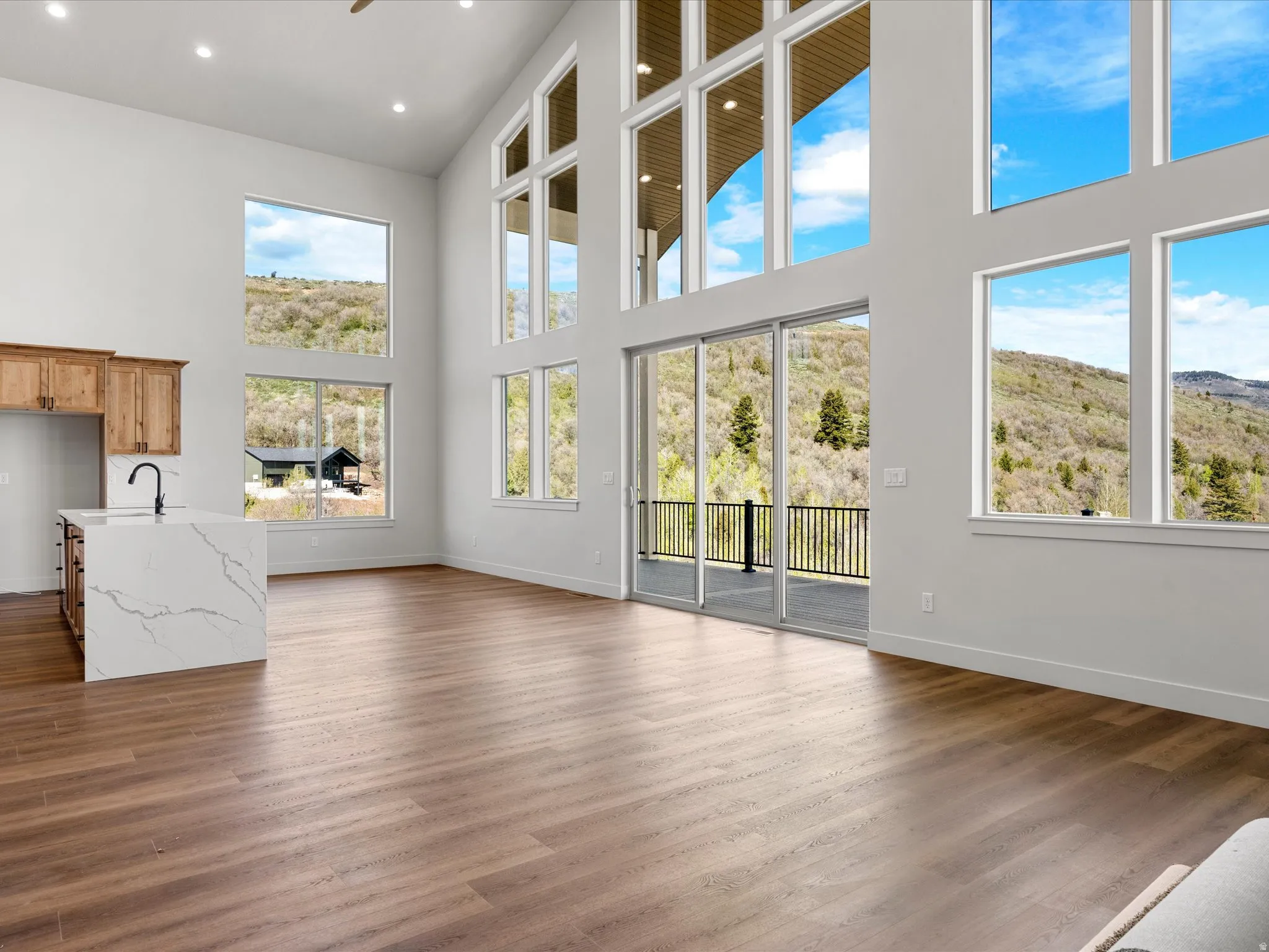 Expansive interior space featuring a vaulted ceiling and numerous floor-to-ceiling windows