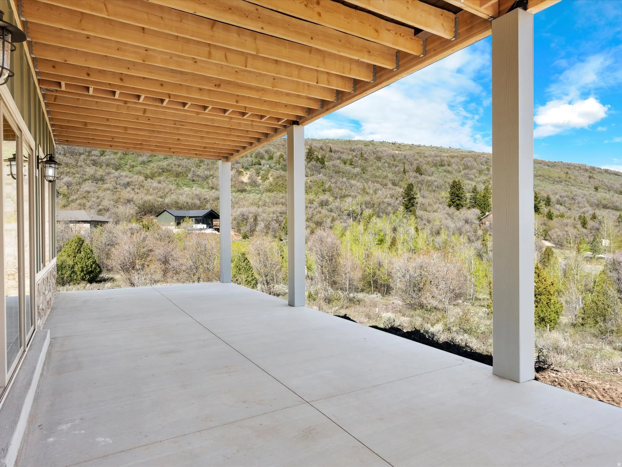 Expansive concrete patio offering an outdoor living area