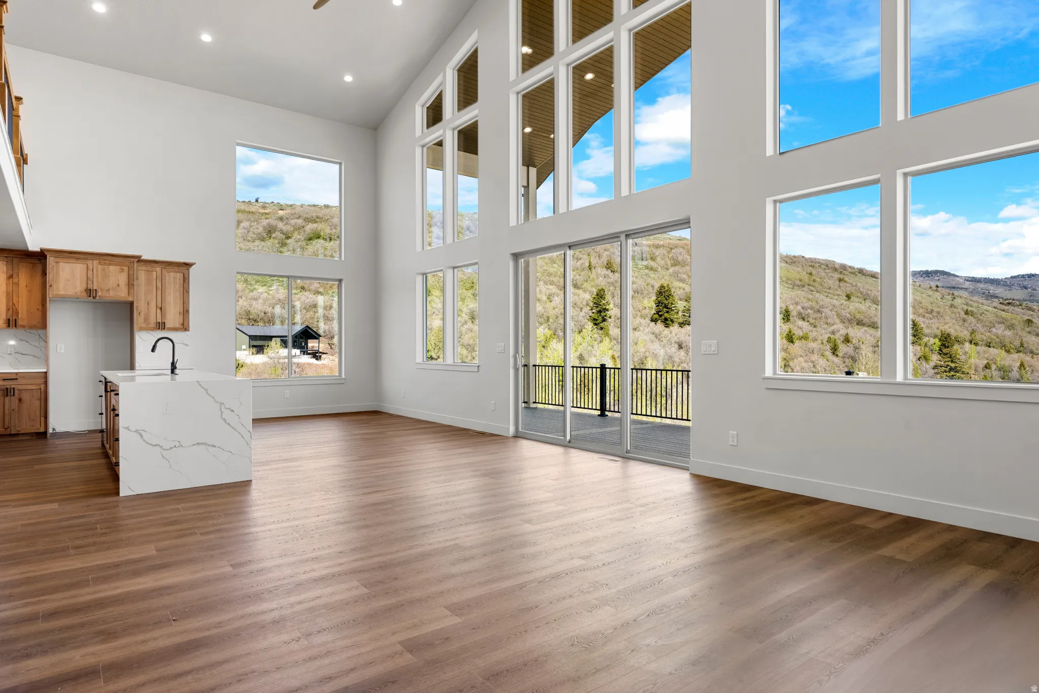 Spacious open-concept living area featuring high ceilings and expansive windows