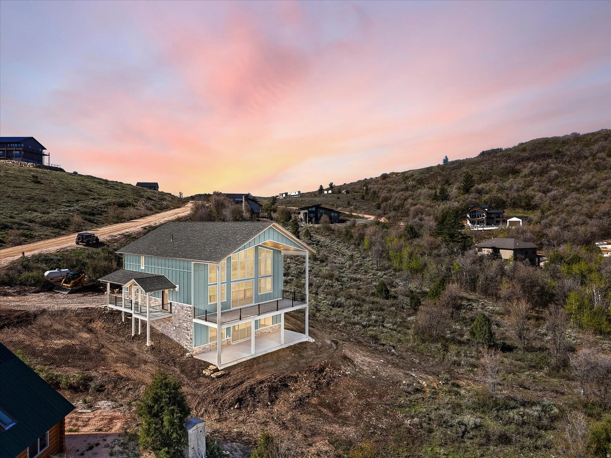 Contemporary architectural style with a gabled roof and light blue vertical siding