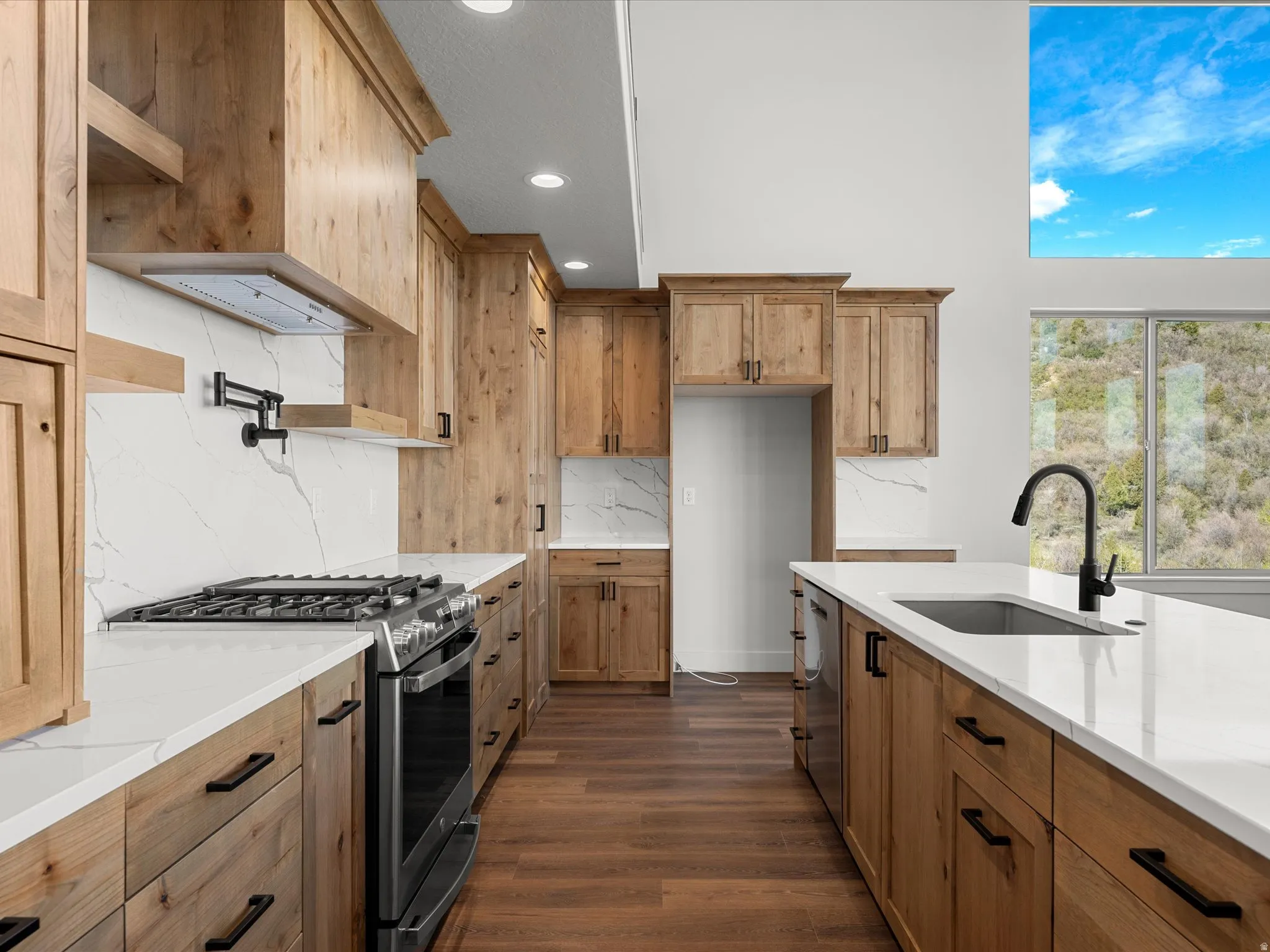 Gourmet kitchen featuring wood-finish cabinetry, white countertops, and full-height backsplash