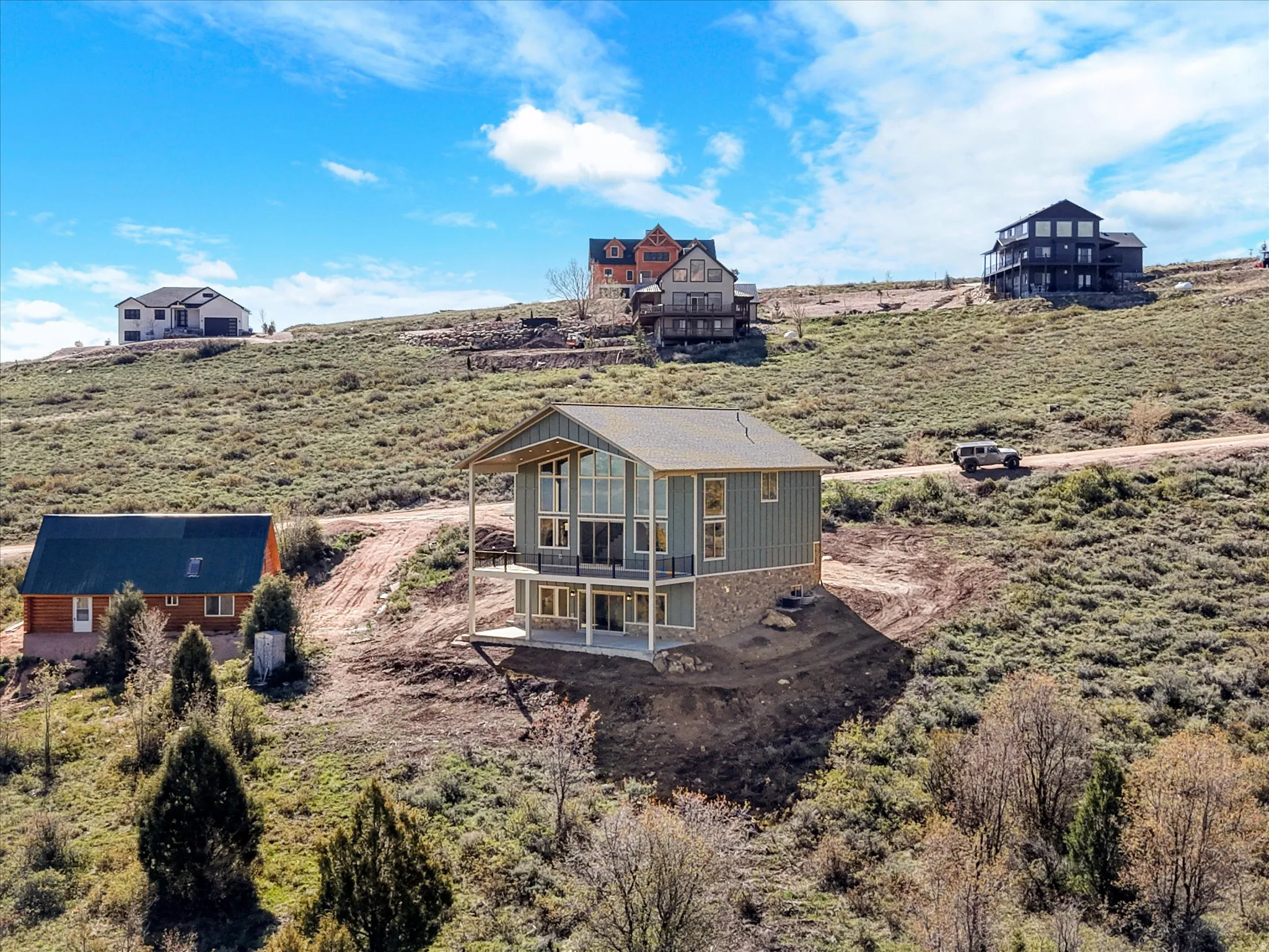 Contemporary multi-level residence featuring vertical siding and an expansive A-frame window design