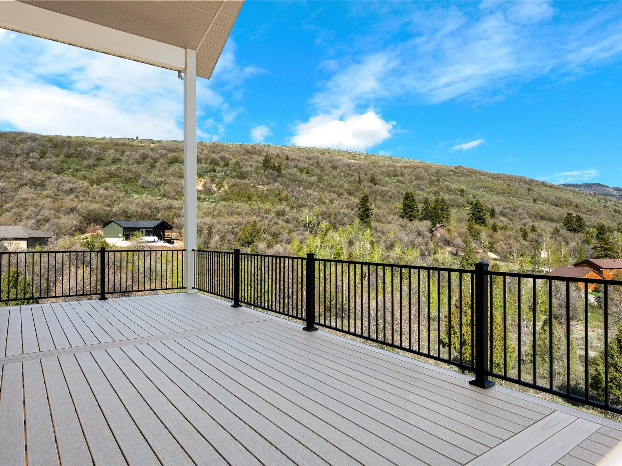 Expansive outdoor deck featuring composite decking and a black metal railing