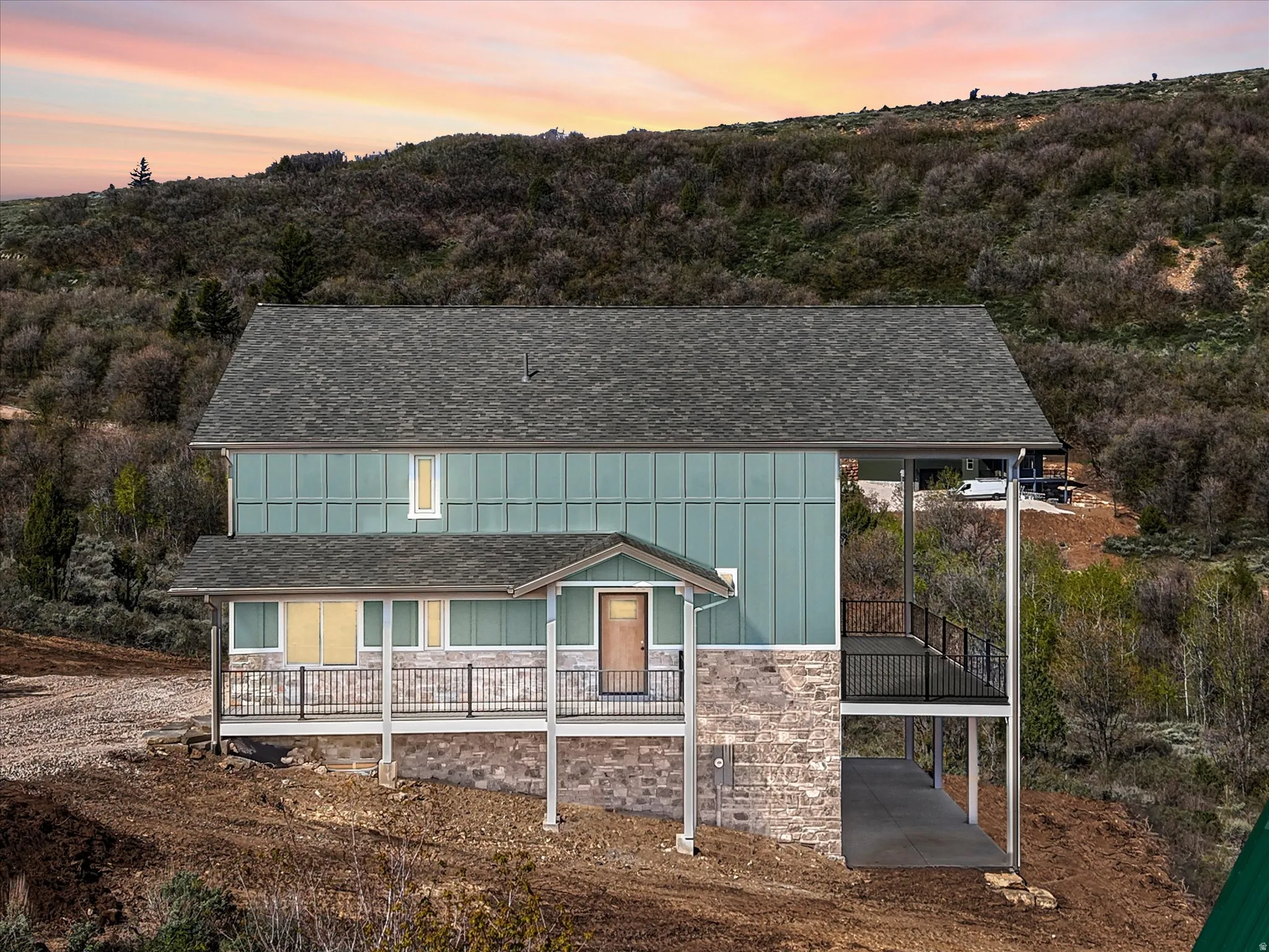 Contemporary exterior featuring blue vertical siding and a stone facade