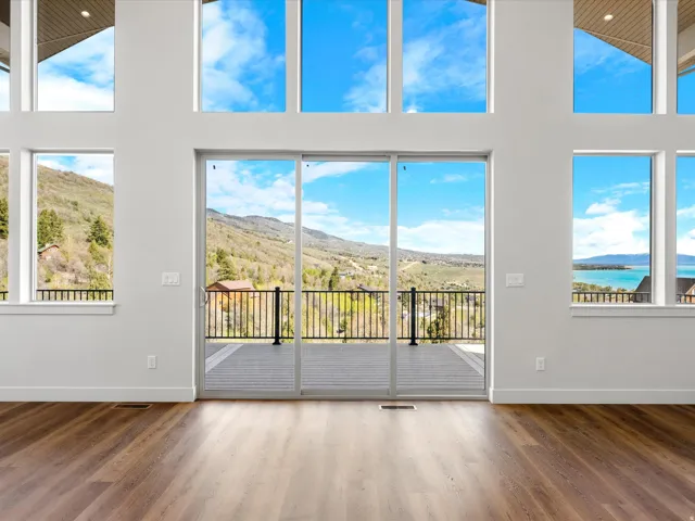 Vaulted ceilings and wood-finish flooring complement the expansive sliding glass doors and multiple windows