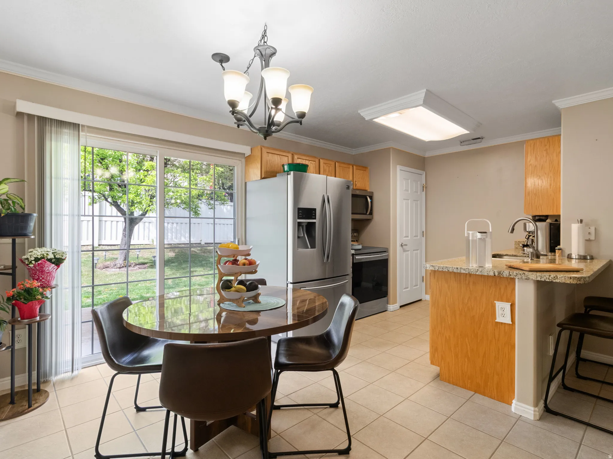 Kitchen with tile flooring and a sliding glass door leading to the backyard